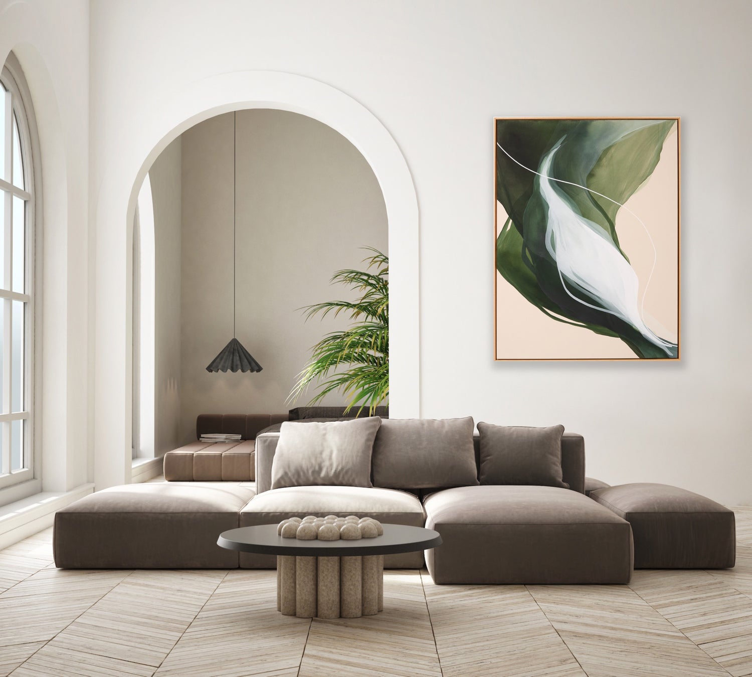 Modern living room with a gray sectional sofa, round coffee table, and a large abstract leaf painting on the wall.